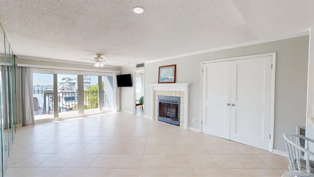 a view of an empty room with a fireplace and a window