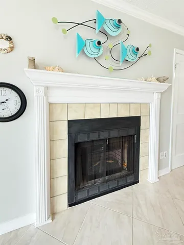 a living room with a fireplace and rug