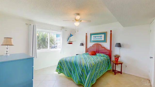 a living room with furniture a chandelier fan and a window