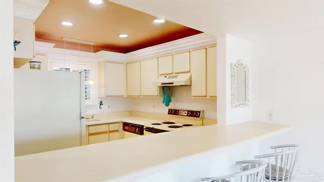 a kitchen with stainless steel appliances a refrigerator and a stove