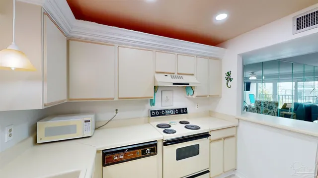 a stove top oven sitting inside of a kitchen