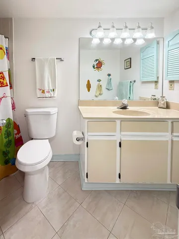 a bathroom with a sink mirror vanity and toilet