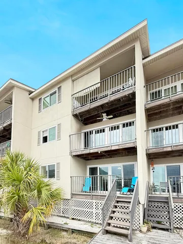 a view of a big house with wooden floor and fence