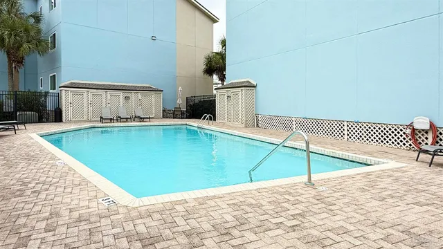 a view of a swimming pool with a lounge chairs