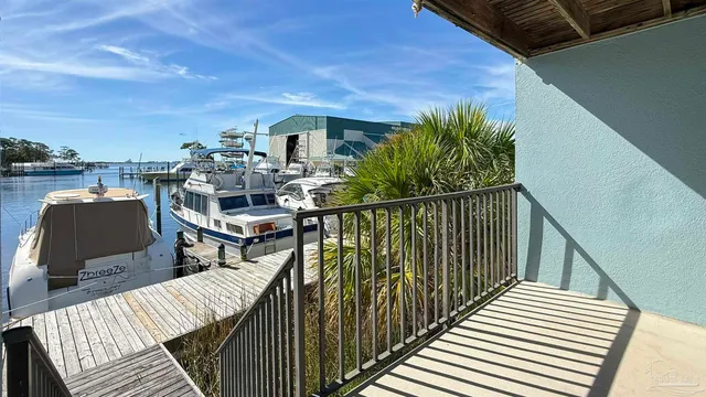 a view of a balcony with wooden floor and outdoor seating