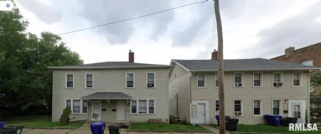 a view of a white building among the front of a house