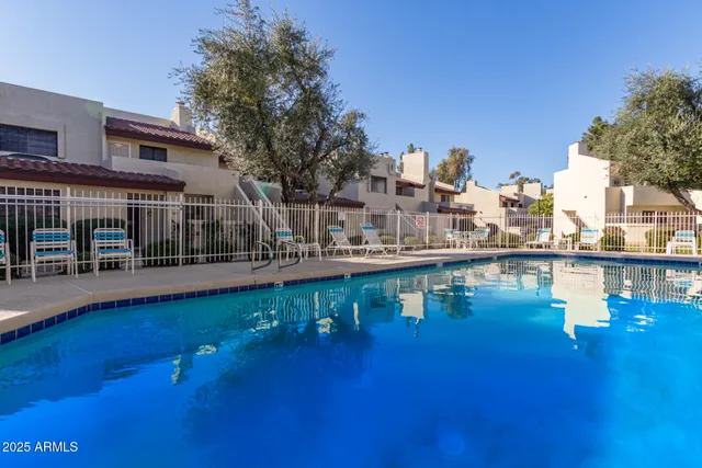 a view of a swimming pool with outdoor seating