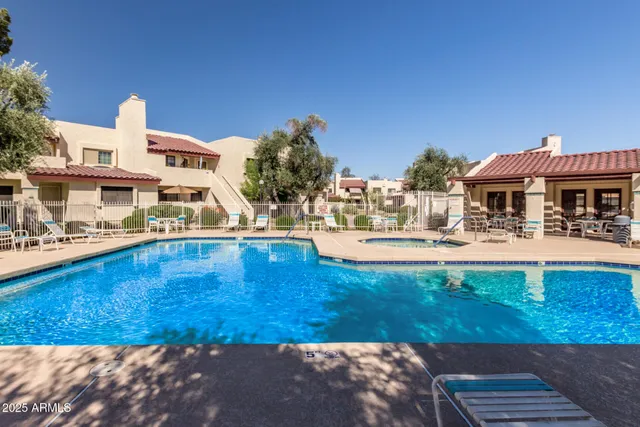 a view of a swimming pool with outdoor seating