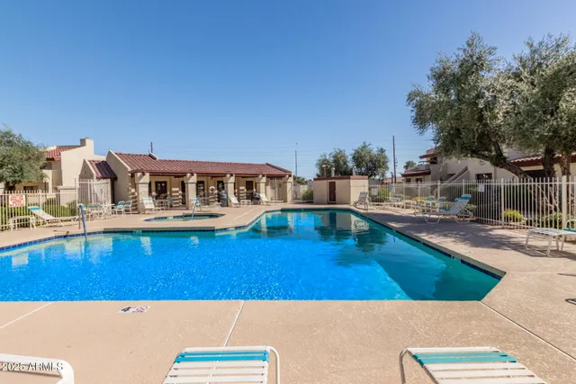 a swimming pool with outdoor seating and yard