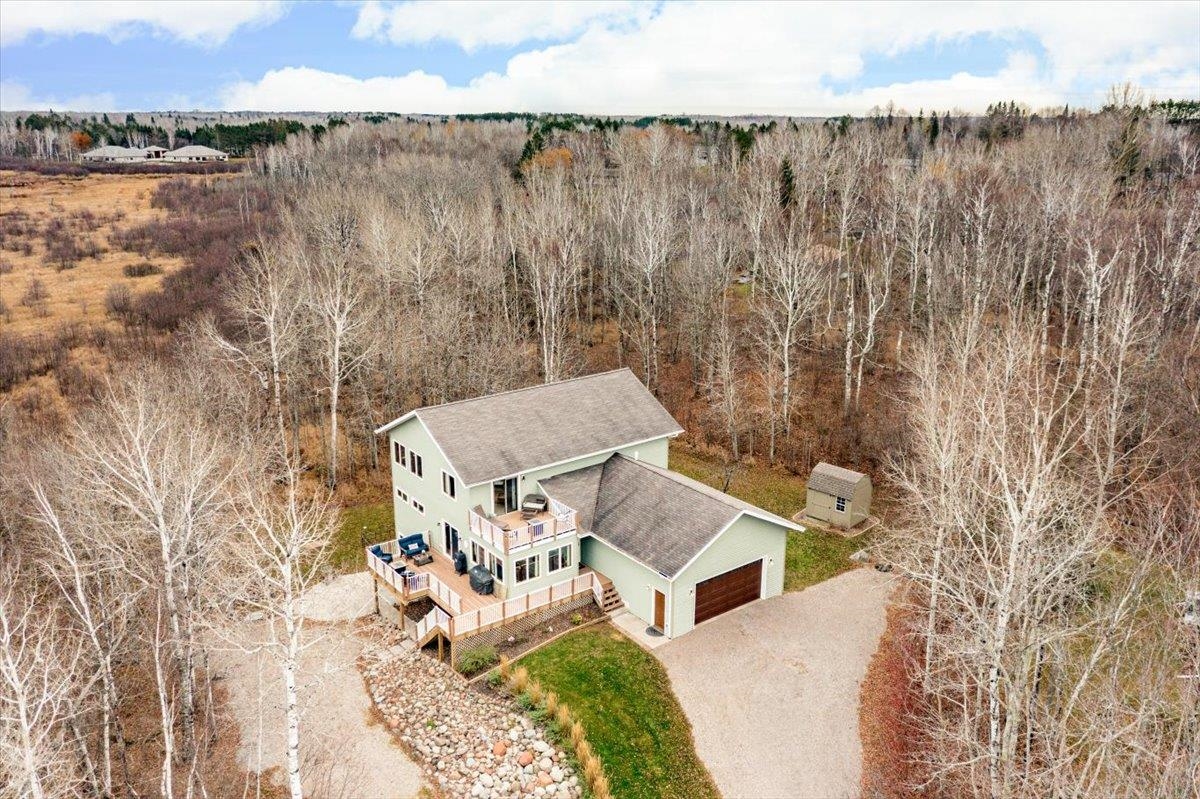 5224 Falcon Drive Hermantown, MN 55811 - Photo 6 of 48 Aerial view of property and surrounding area featuring a heavily wooded area