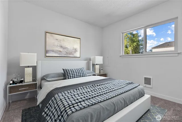 a bedroom with a large bed and a window