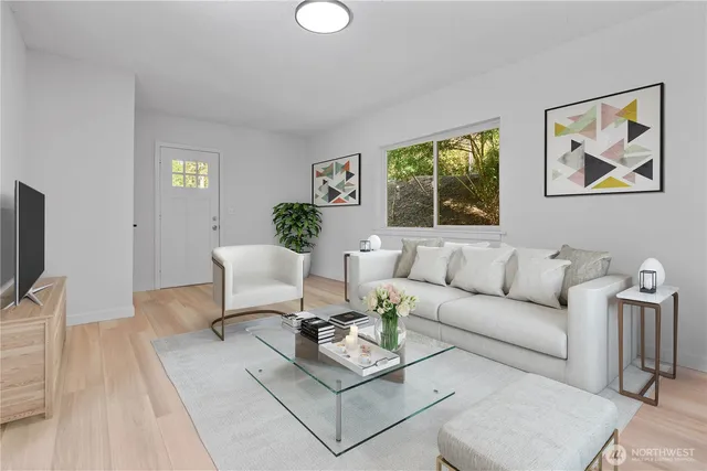 a living room with furniture a rug and a flat screen tv