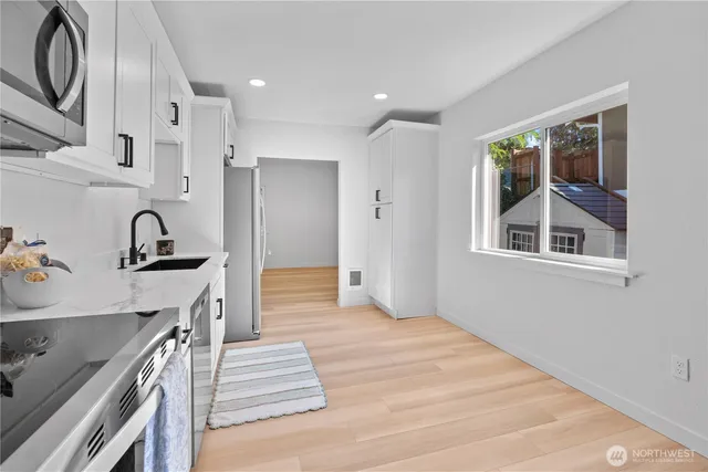 a kitchen with stainless steel appliances granite countertop a stove and a sink