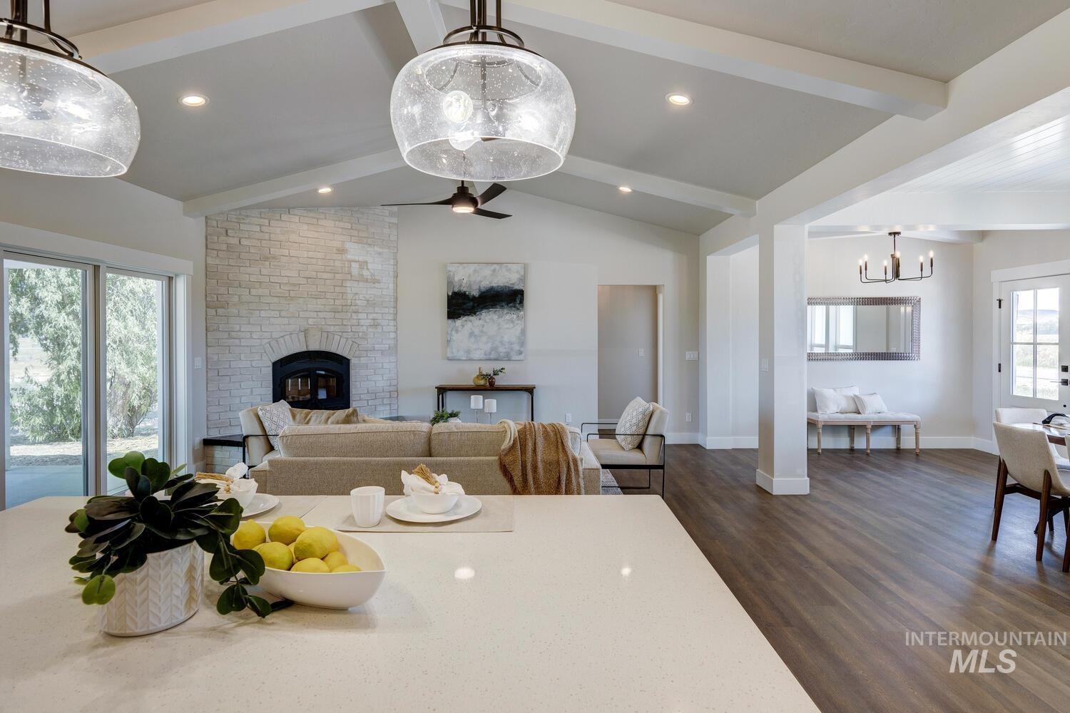 4695 County Line Road New Plymouth, ID 83655 - Photo 18 of 49 Dining space with dark wood-type flooring, a brick fireplace, a chandelier, and recessed lighting