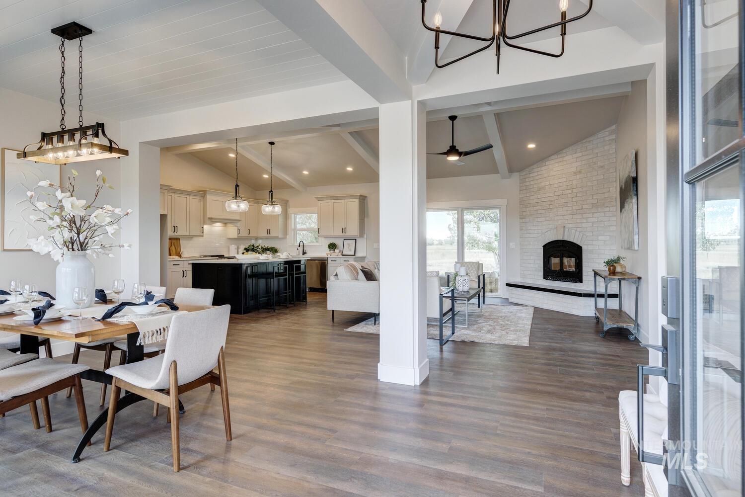 4695 County Line Road New Plymouth, ID 83655 - Photo 19 of 49 Dining space with a chandelier, dark wood finished floors, a brick fireplace, and ceiling fan