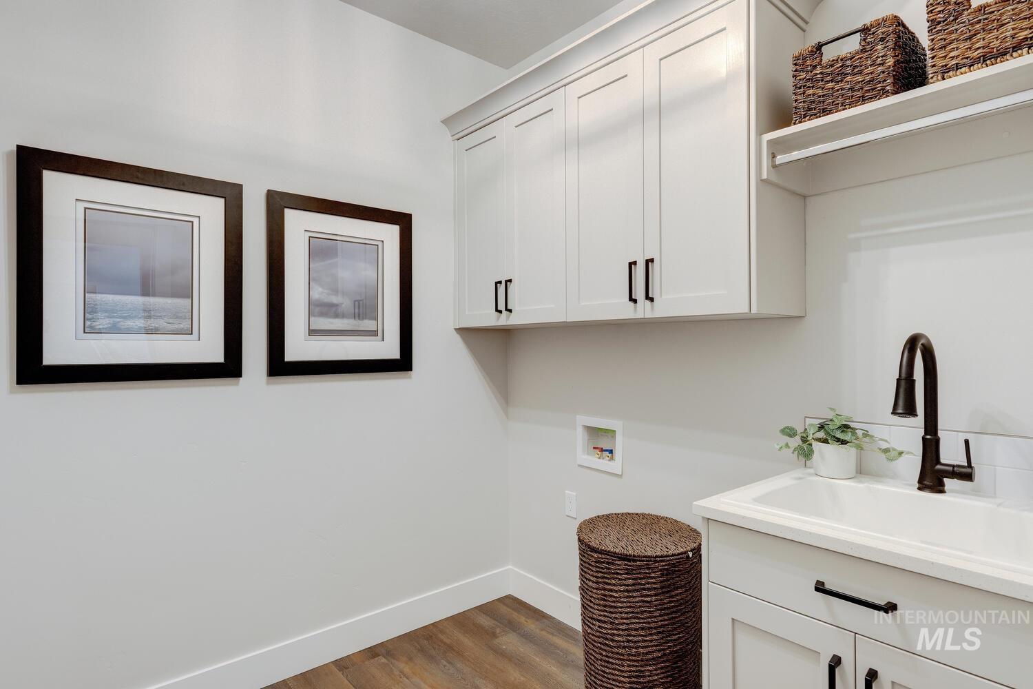 4695 County Line Road New Plymouth, ID 83655 - Photo 32 of 49 Laundry area featuring cabinet space, washer hookup, and wood finished floors