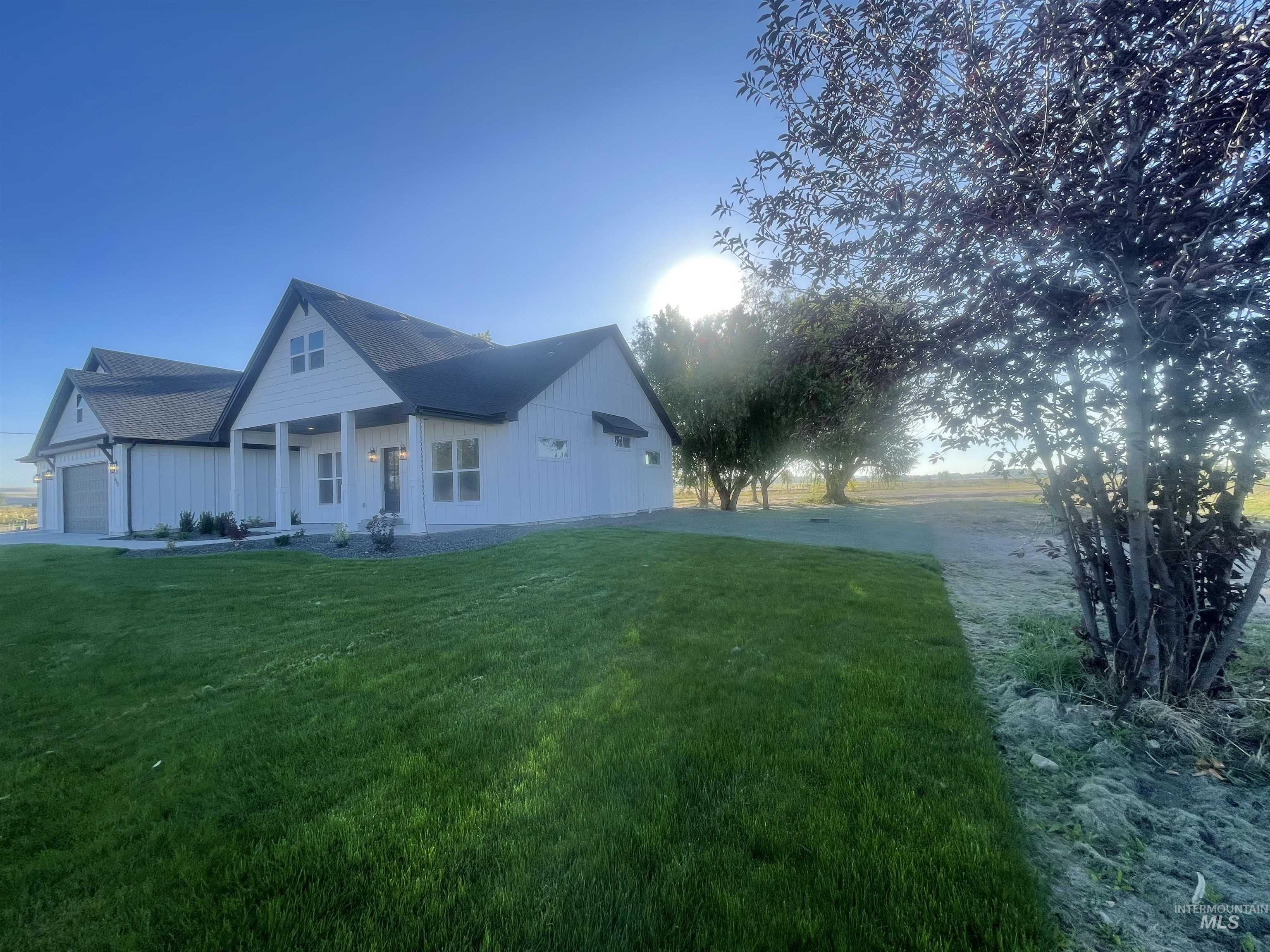 4695 County Line Road New Plymouth, ID 83655 - Photo 47 of 49 View of side of property with a porch, a yard, a garage, and roof with shingles