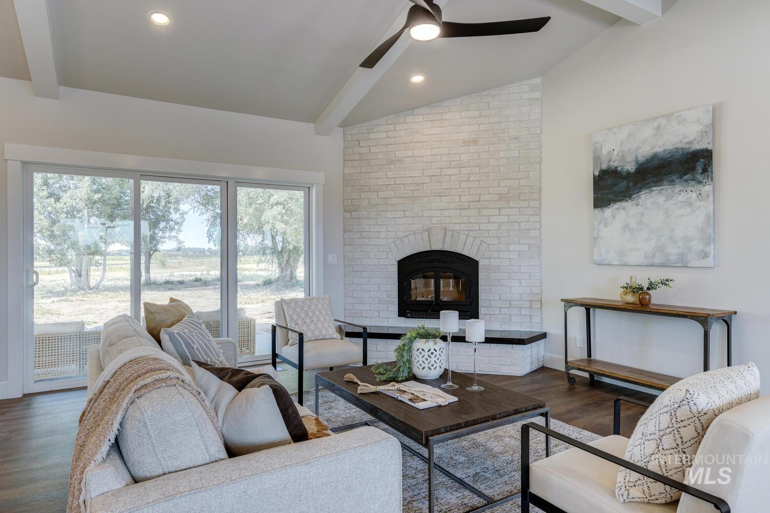 4695 County Line Road New Plymouth, ID 83655 - Photo 8 of 49 Living area with wood finished floors, a fireplace, and a ceiling fan