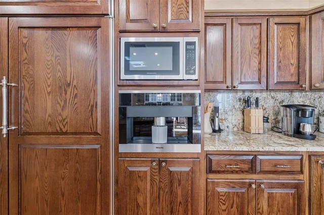 a bathroom with a sink mirror vanity and toilet