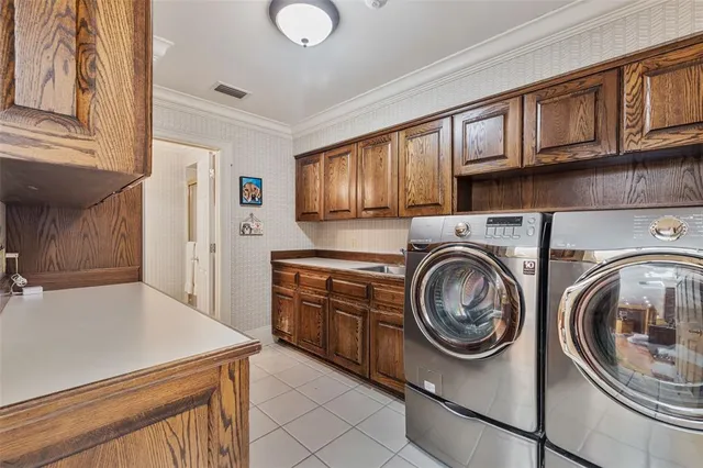 a view of walk in closet with clothes