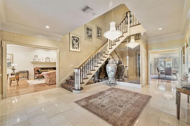 a dining room with furniture a chandelier and wooden floor