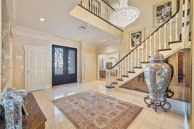 a living room with furniture and a chandelier