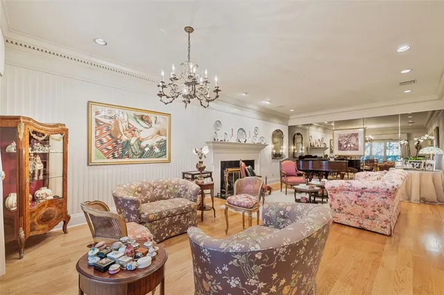 a living room with furniture and a chandelier