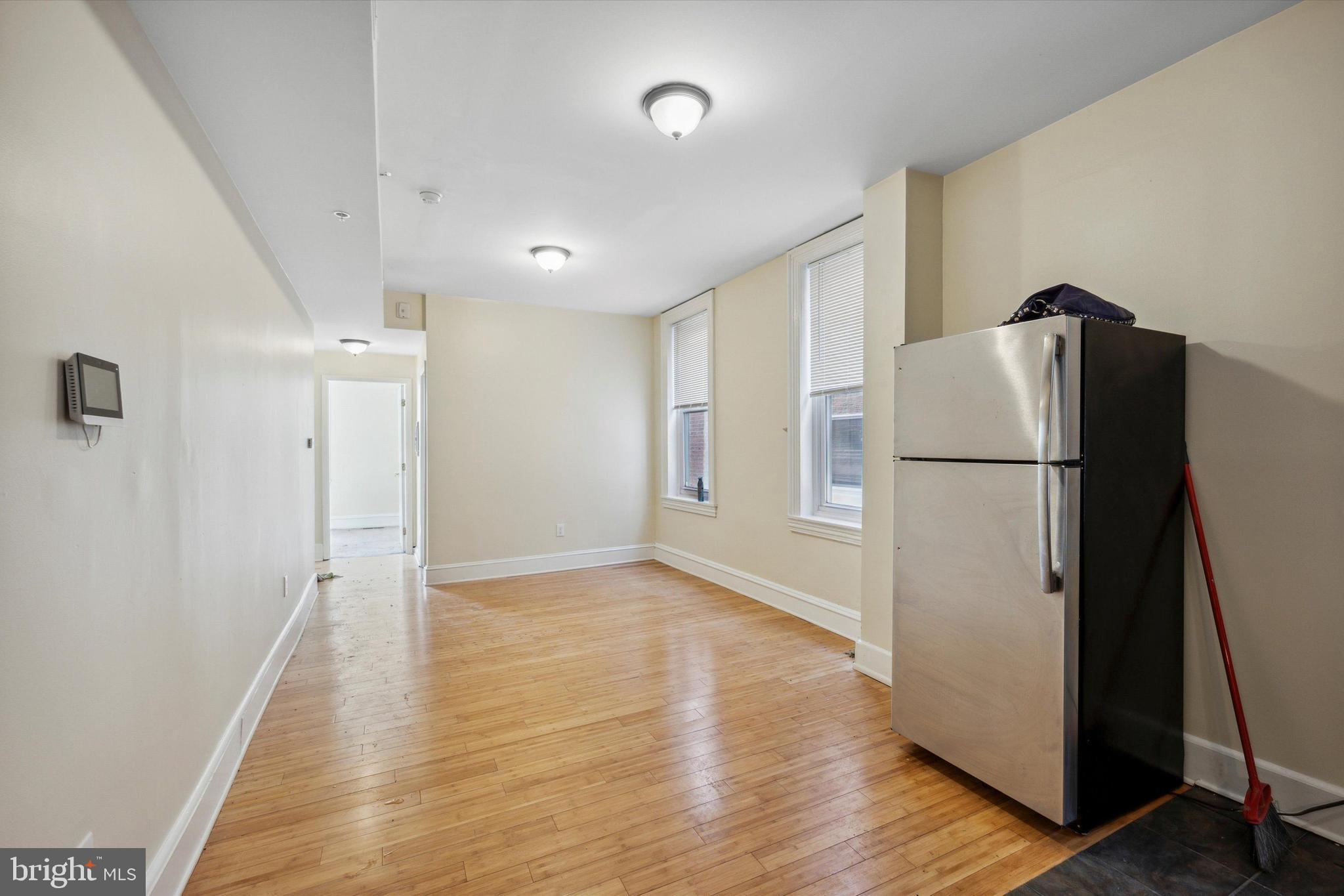 413 North Preston Street Philadelphia, PA 19104 - Photo 13 of 15 a view of a refrigerator in kitchen and wooden floor