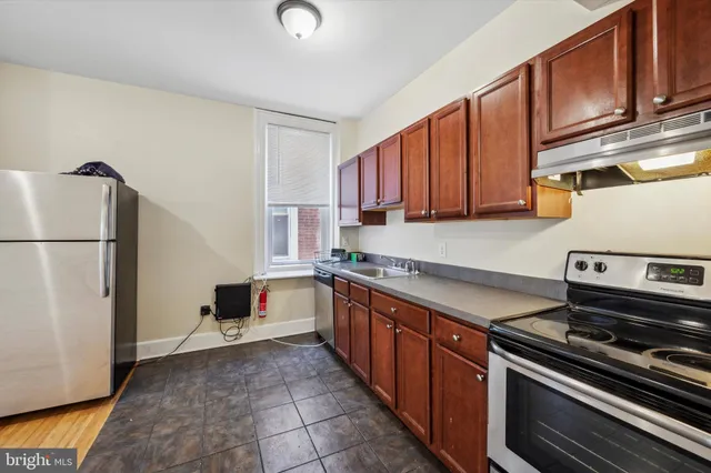 a kitchen with stainless steel appliances granite countertop a stove a refrigerator and a refrigerator