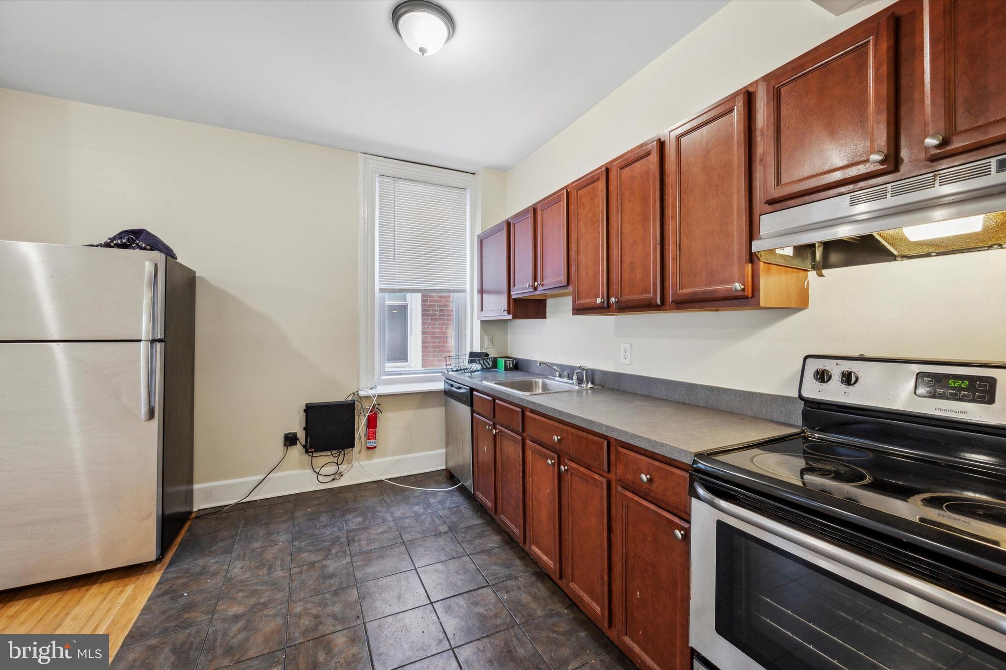 413 North Preston Street Philadelphia, PA 19104 - Photo 15 of 15 a kitchen with stainless steel appliances granite countertop a stove a refrigerator and a refrigerator