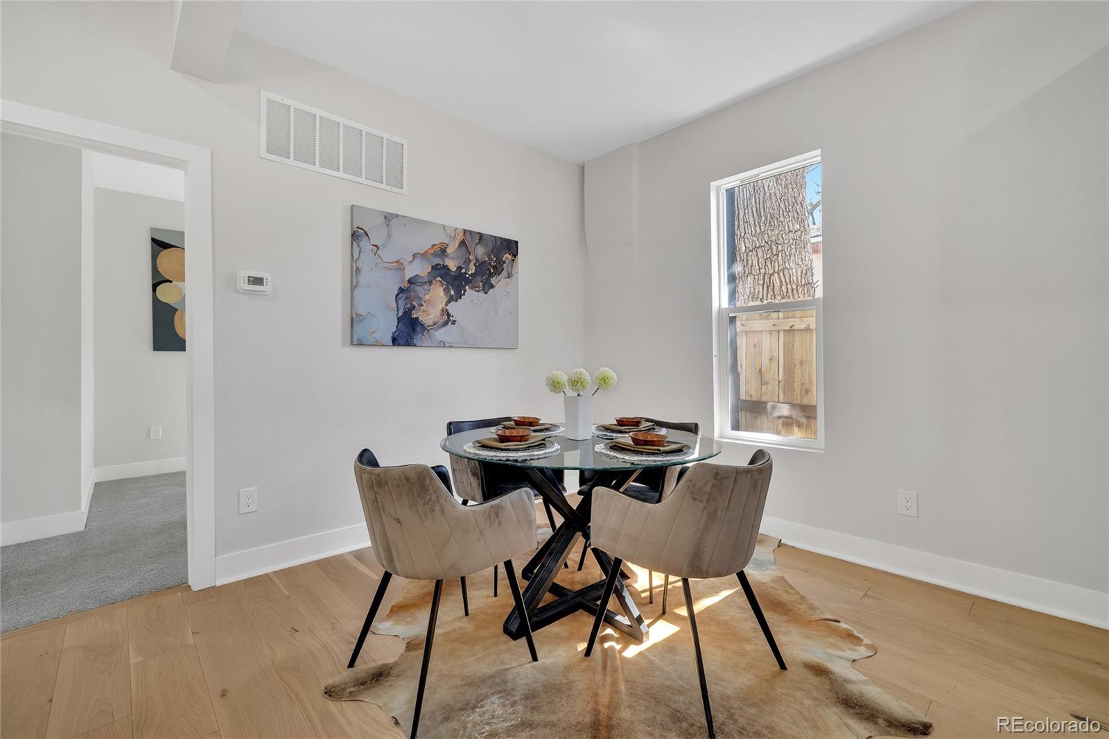 3512 High Street Denver, CO 80205 - Photo 11 of 33 a view of a dining room with furniture and wooden floor