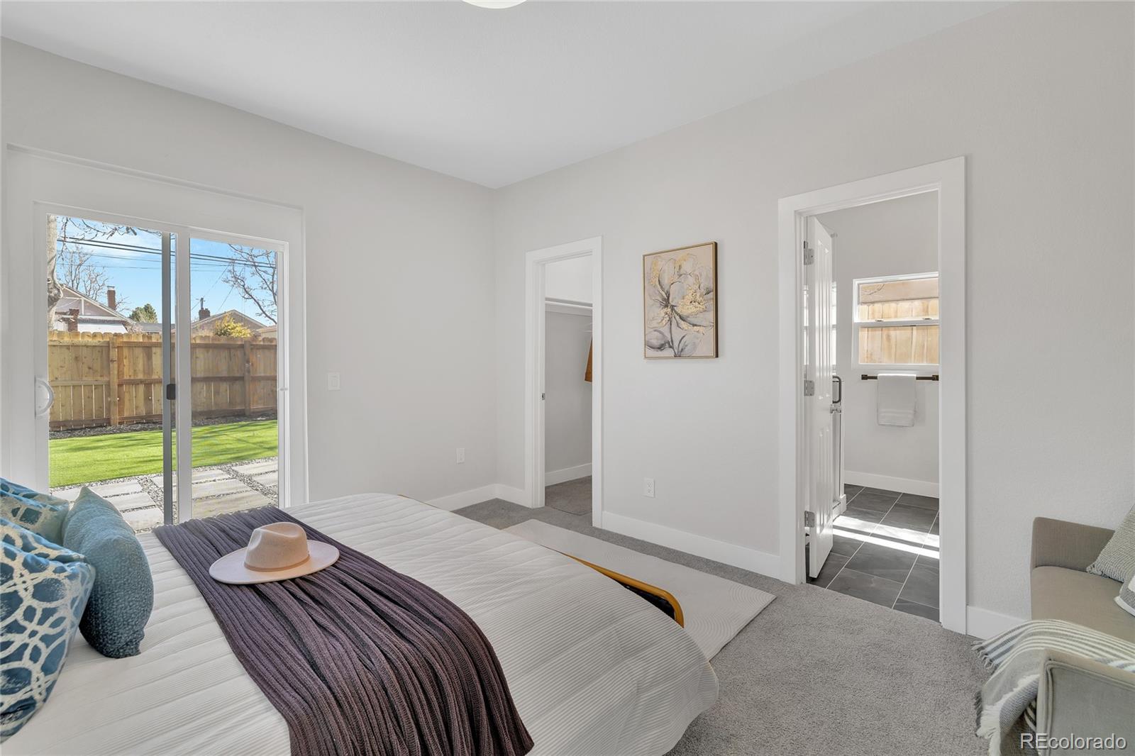 3512 High Street Denver, CO 80205 - Photo 14 of 33 a bedroom with a bed and glass window