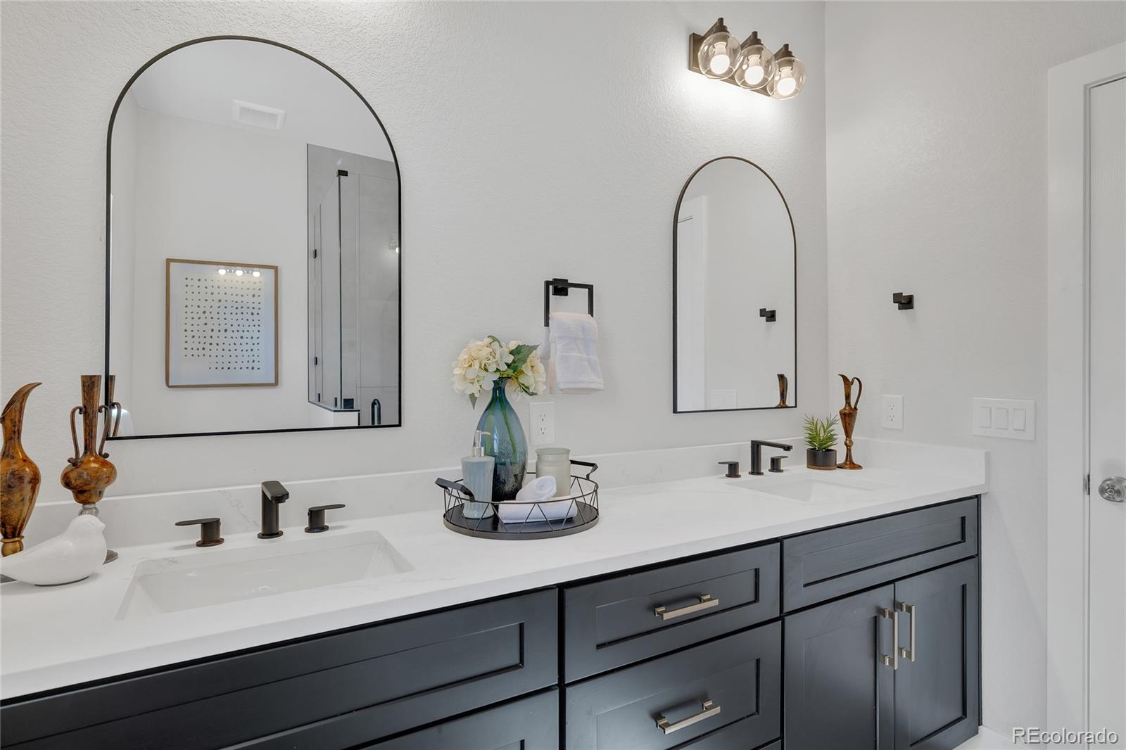 3512 High Street Denver, CO 80205 - Photo 16 of 33 a bathroom with a double vanity sink and a mirror