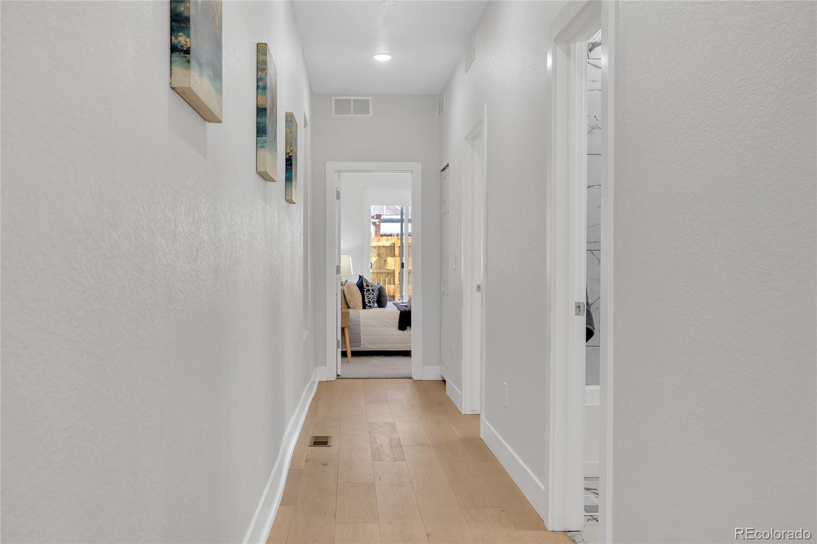 3512 High Street Denver, CO 80205 - Photo 19 of 33 a view of a hallway with a livingroom and a bathroom with a sink