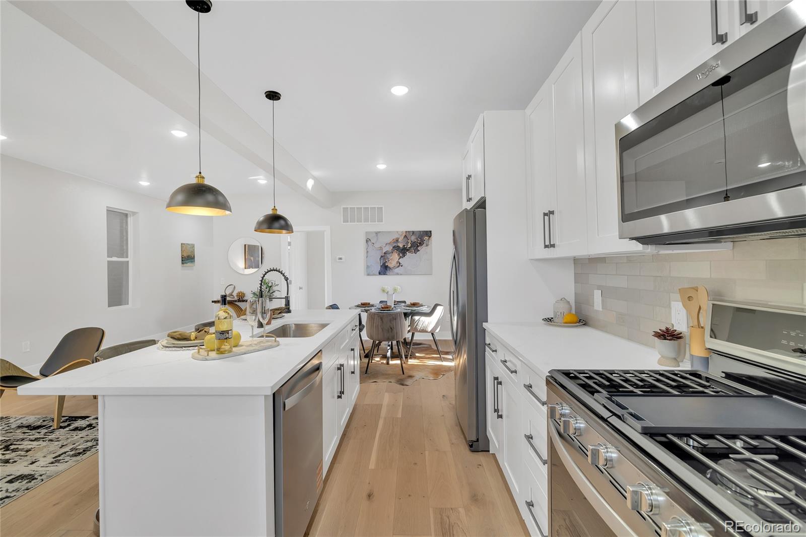 3512 High Street Denver, CO 80205 - Photo 2 of 33 a kitchen with stainless steel appliances granite countertop a stove and a sink