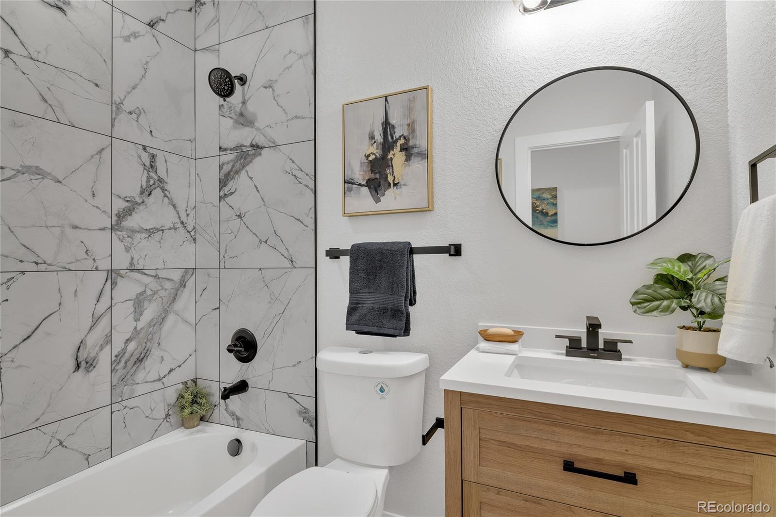 3512 High Street Denver, CO 80205 - Photo 24 of 33 a bathroom with a sink a toilet and a mirror