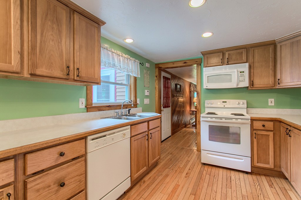 99 Mirick Road Princeton, MA 01541 - Photo 19 of 30 a kitchen with granite countertop wooden cabinets and white appliances