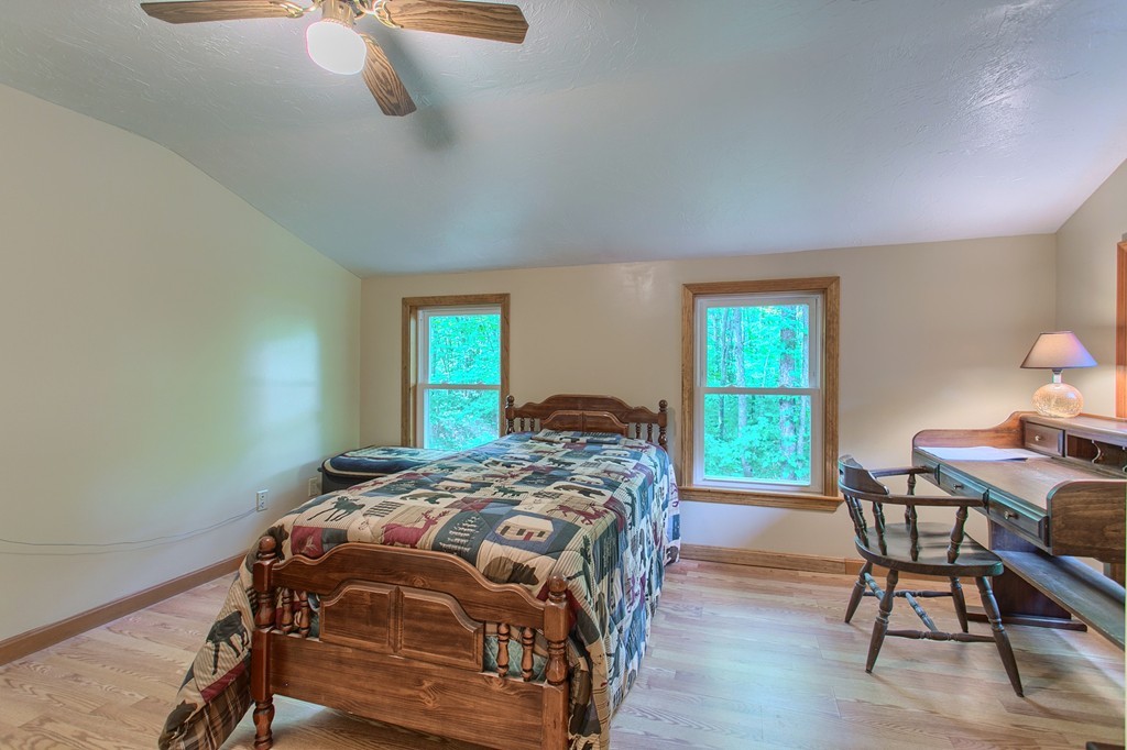 99 Mirick Road Princeton, MA 01541 - Photo 23 of 30 a bedroom with a bed and a table in it