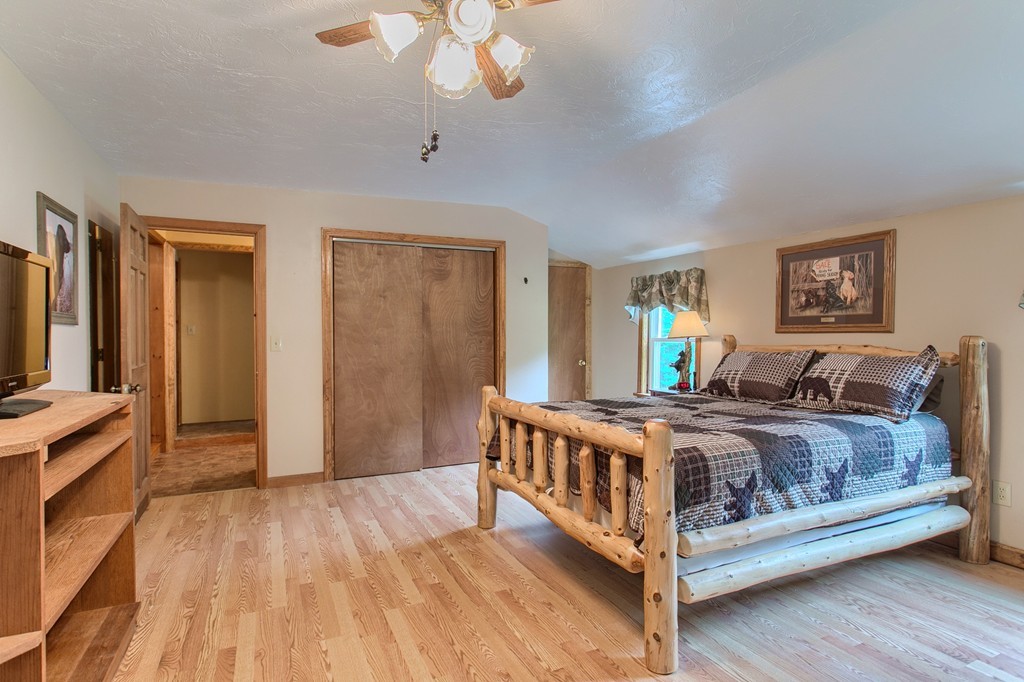 99 Mirick Road Princeton, MA 01541 - Photo 29 of 30 a large bedroom with a bed and wooden floor