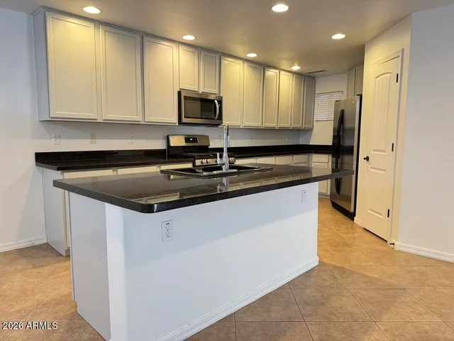 a stove top oven sitting inside of a kitchen