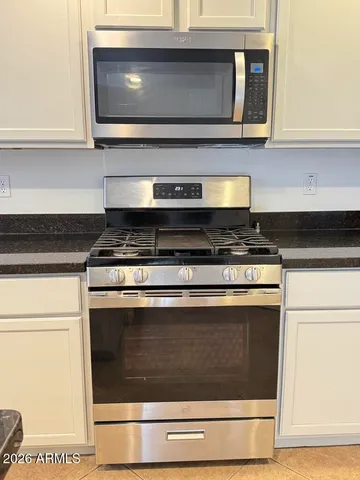 a kitchen with stainless steel appliances granite countertop a sink and cabinets