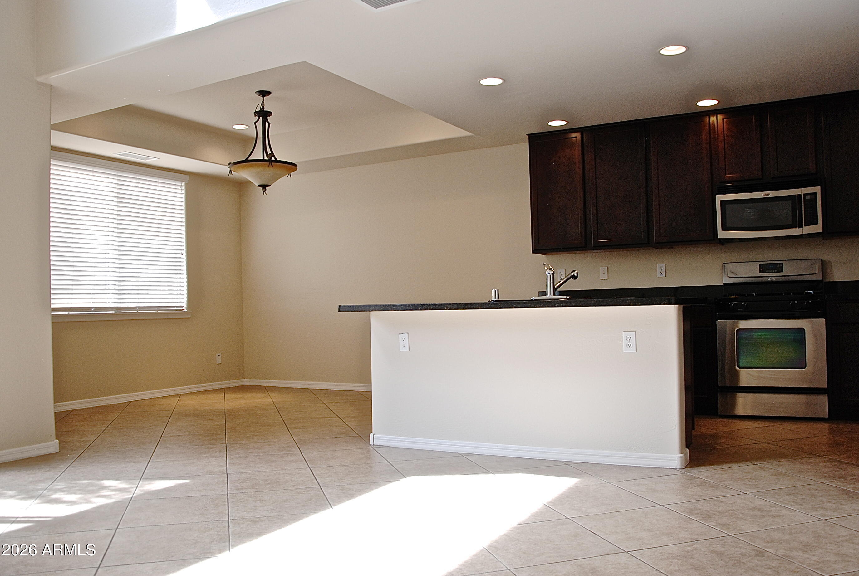 2611 North 48th Street, Unit 4 Phoenix, AZ 85008 - Photo 7 of 23 a kitchen with a sink a microwave and cabinets