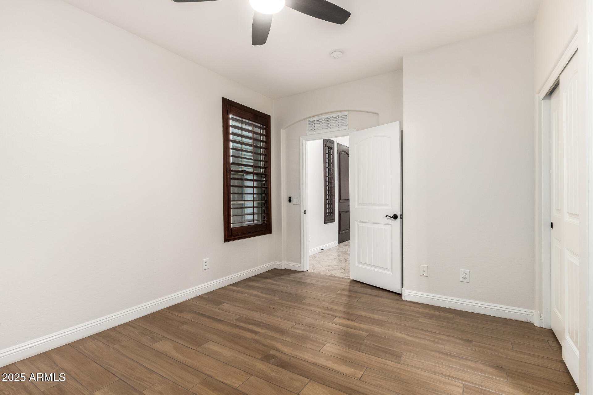 19263 East Estrella Road Queen Creek, AZ 85142 - Photo 25 of 53 an empty room with wooden floor and windows