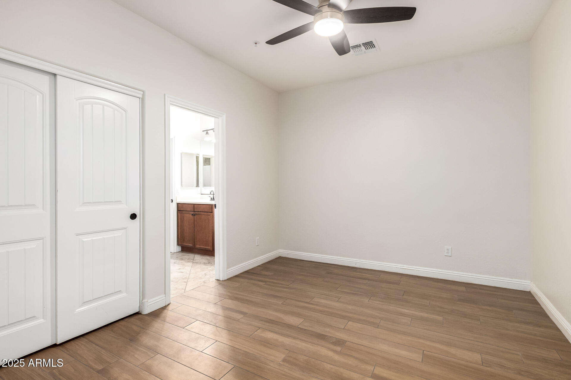 19263 East Estrella Road Queen Creek, AZ 85142 - Photo 26 of 53 wooden floor in an empty room with a window