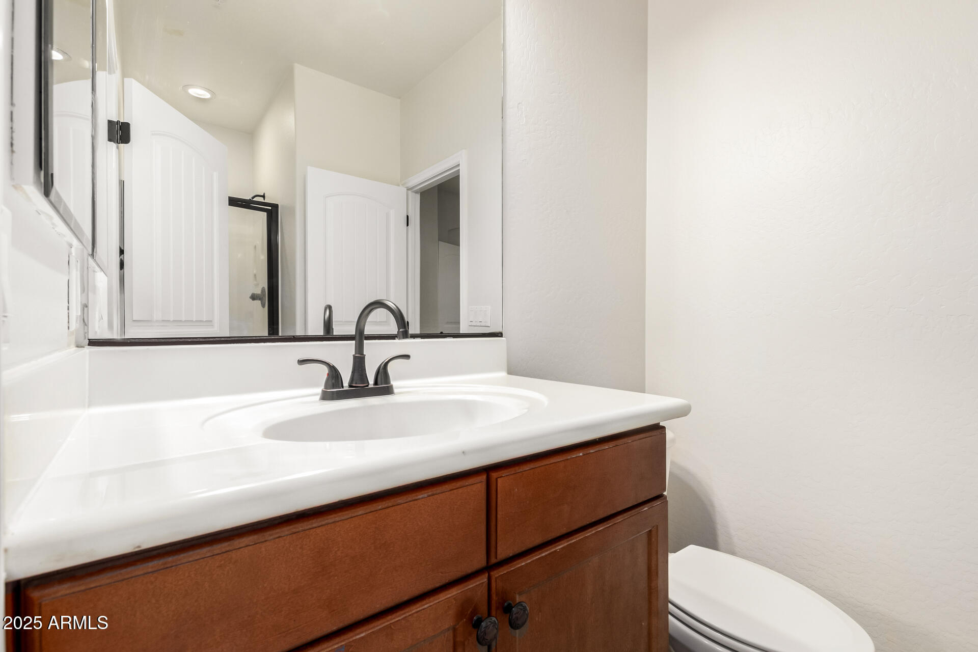 19263 East Estrella Road Queen Creek, AZ 85142 - Photo 27 of 53 a bathroom with a sink a toilet and mirror