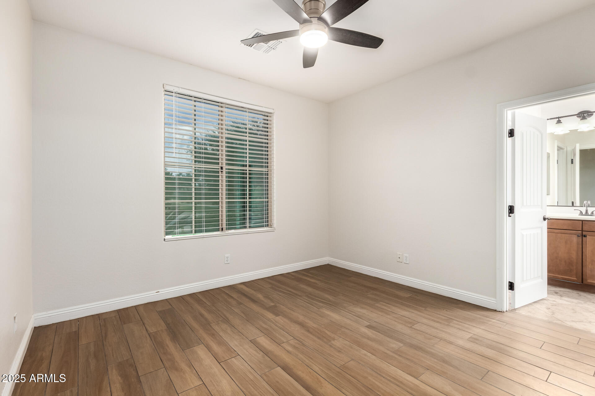 19263 East Estrella Road Queen Creek, AZ 85142 - Photo 29 of 53 a view of a room with wooden floor and windows