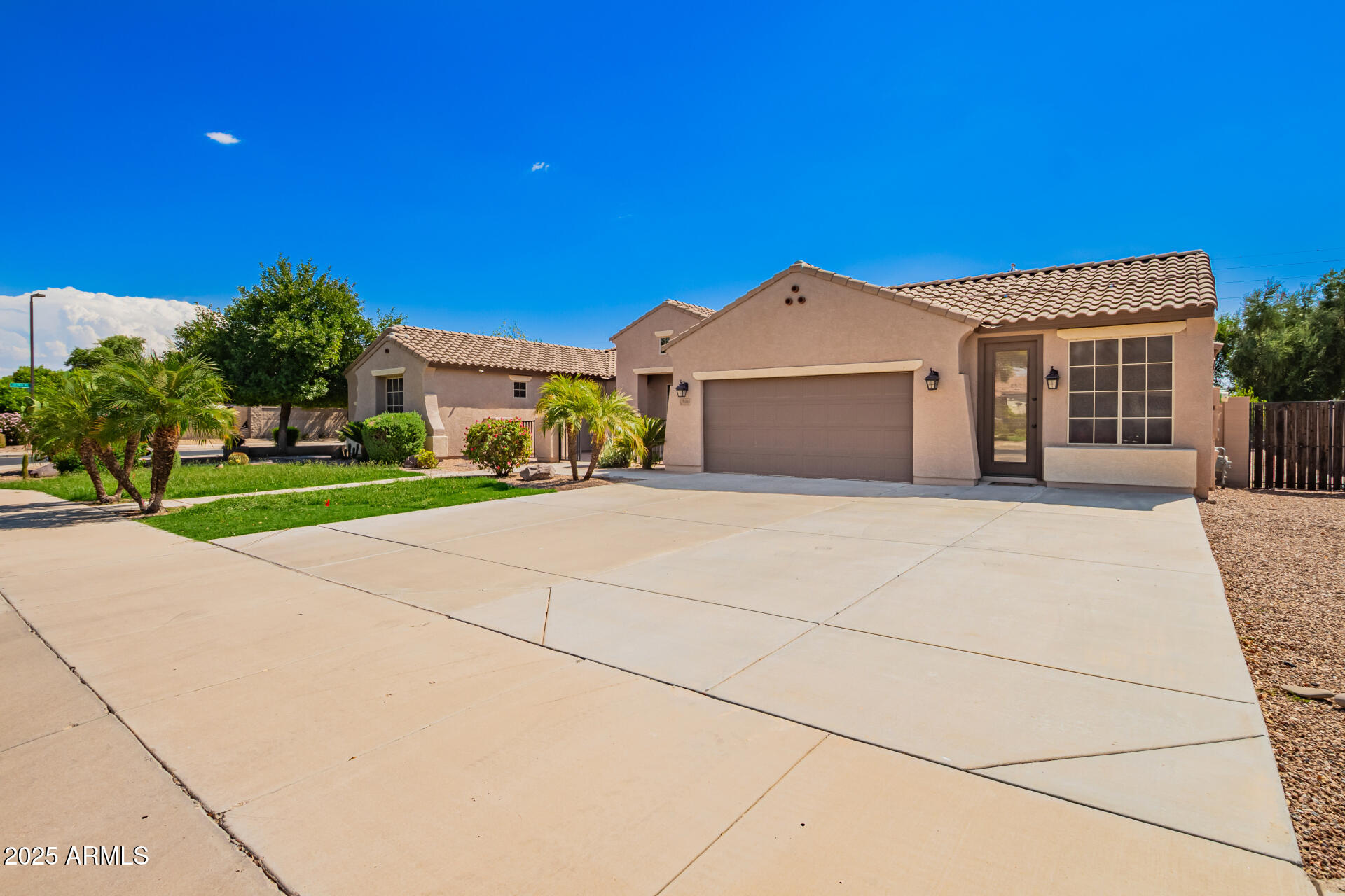 19263 East Estrella Road Queen Creek, AZ 85142 - Photo 3 of 53 a front view of a house with a yard and potted plants