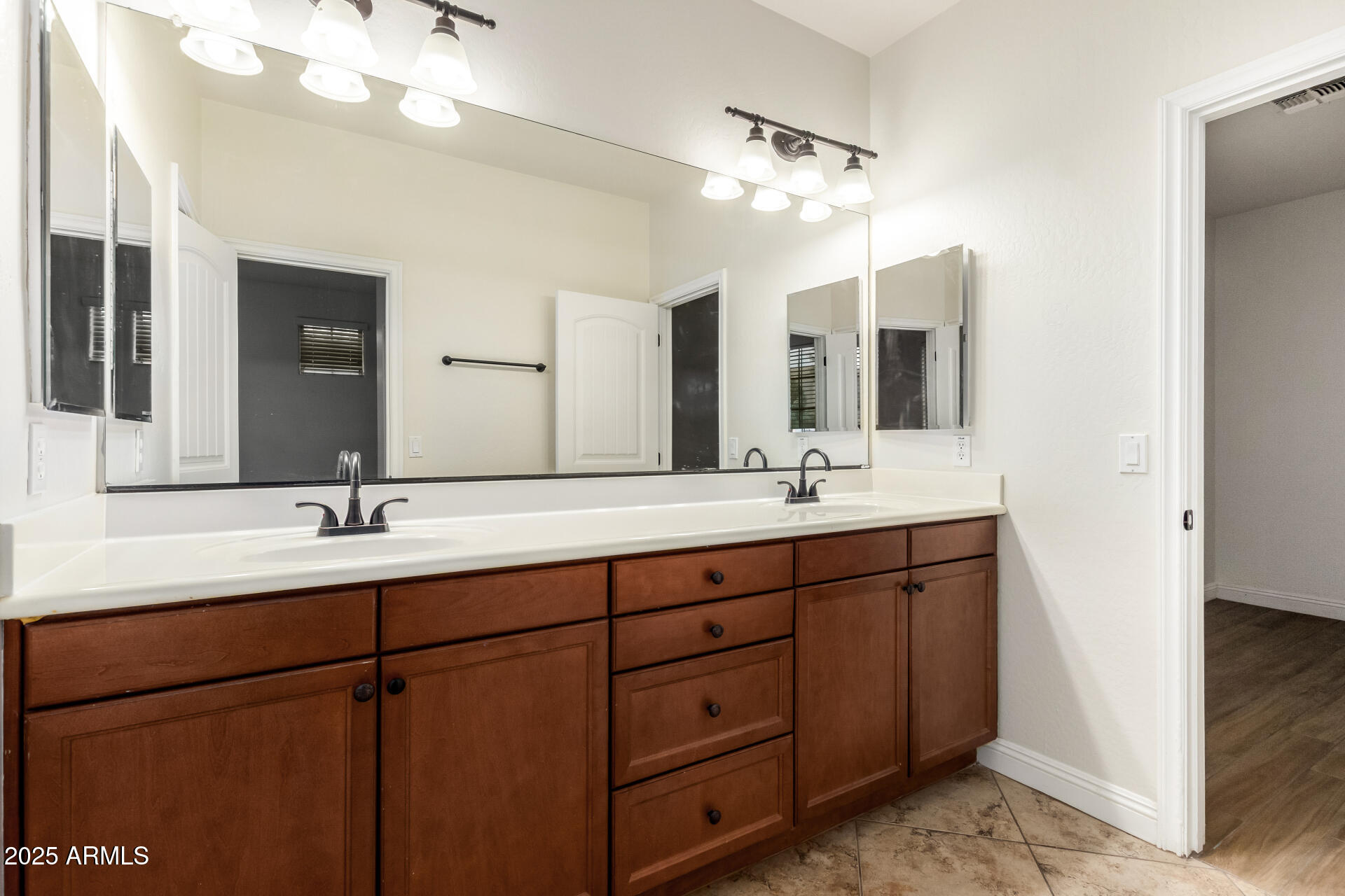 19263 East Estrella Road Queen Creek, AZ 85142 - Photo 31 of 53 a bathroom with double vanity sinks and a mirror