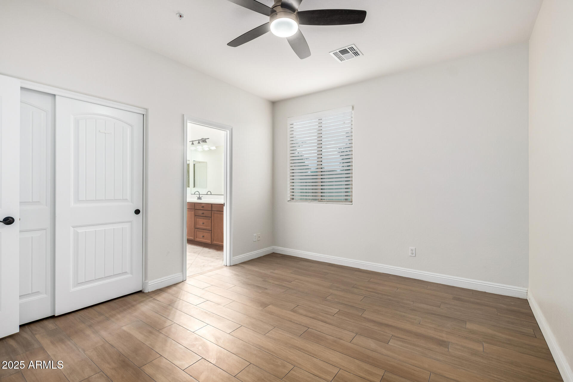 19263 East Estrella Road Queen Creek, AZ 85142 - Photo 34 of 53 an empty room with wooden floor chandelier fan and windows