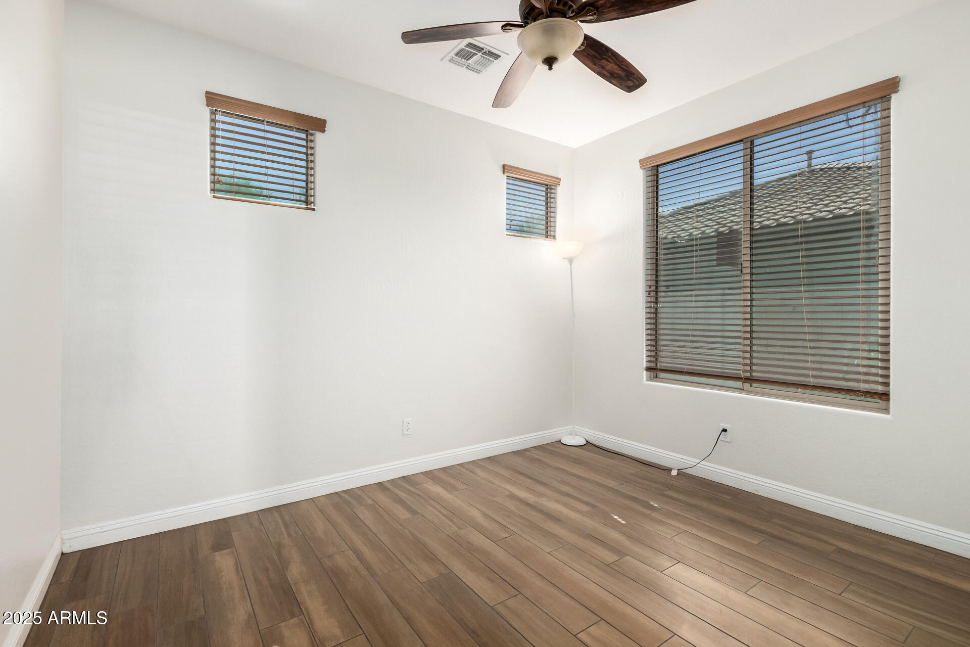 19263 East Estrella Road Queen Creek, AZ 85142 - Photo 36 of 53 a view of an empty room with wooden floor and a window